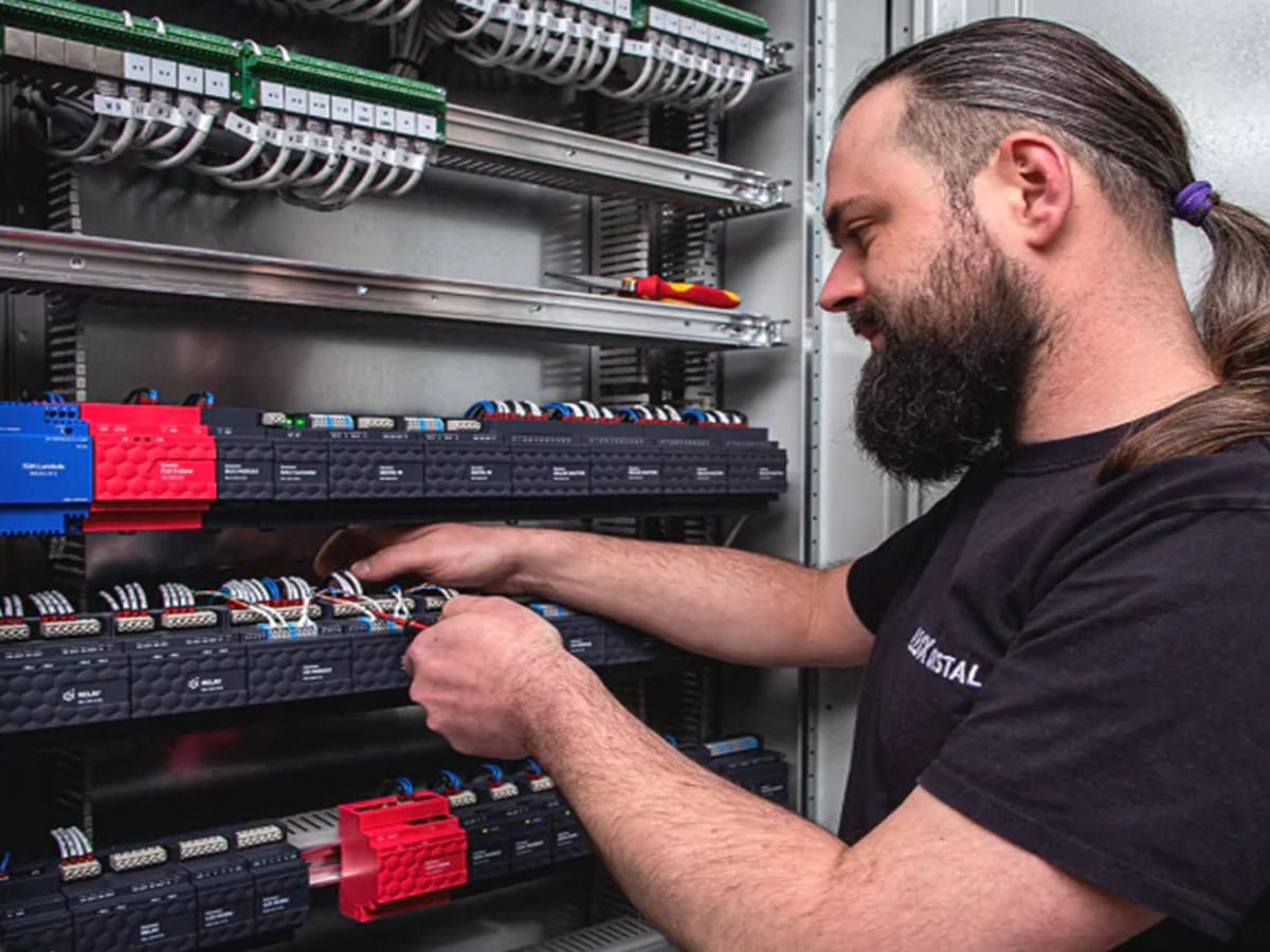 Installateur électricien posant un panneau domotique premium